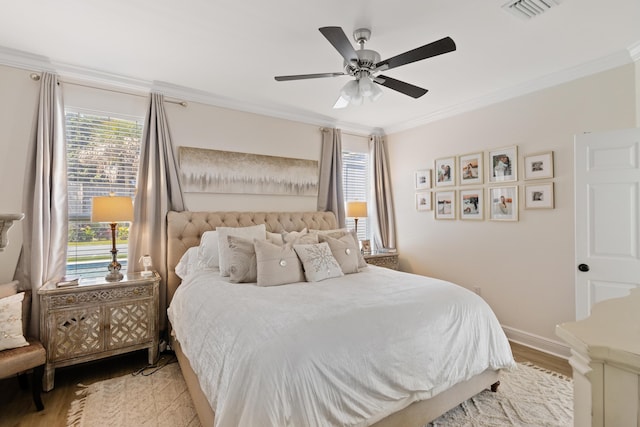1009 Forest Shore Dr, Miramar Beach, FL 32550 - bedroom with light wood-style floors, multiple windows, crown molding, and ceiling fan