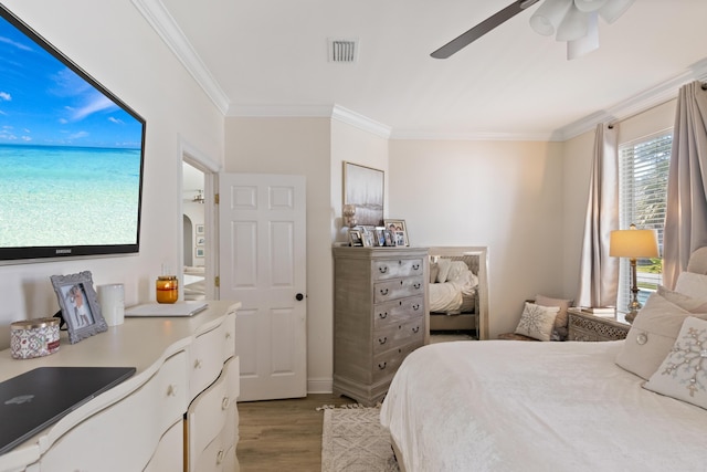1009 Forest Shore Dr, Miramar Beach, FL 32550 - bedroom featuring wood finished floors, crown molding, and a ceiling fan