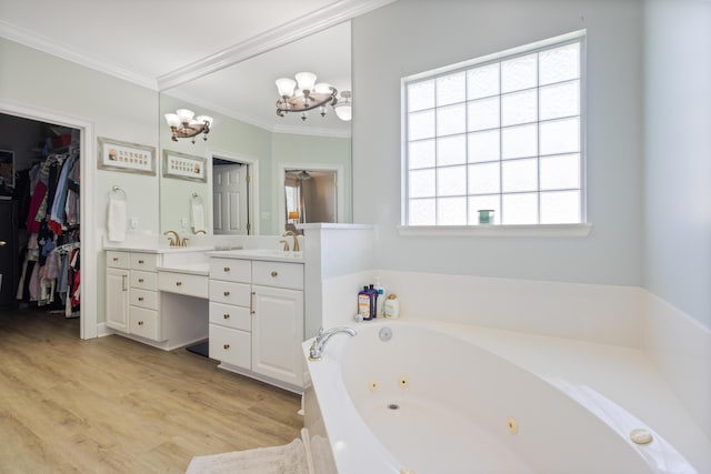 1009 Forest Shore Dr, Miramar Beach, FL 32550 - bathroom featuring double vanity, a tub with jets, ornamental molding, wood finished floors, and a chandelier