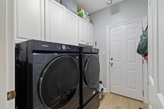 1009 Forest Shore Dr, Miramar Beach, FL 32550 - laundry room featuring washing machine and clothes dryer, cabinet space, and light wood-style floors