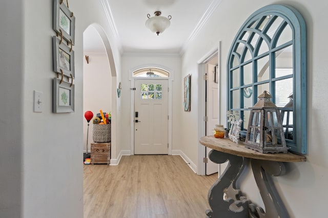 1009 Forest Shore Dr, Miramar Beach, FL 32550 - entryway with arched walkways, light wood finished floors, and crown molding
