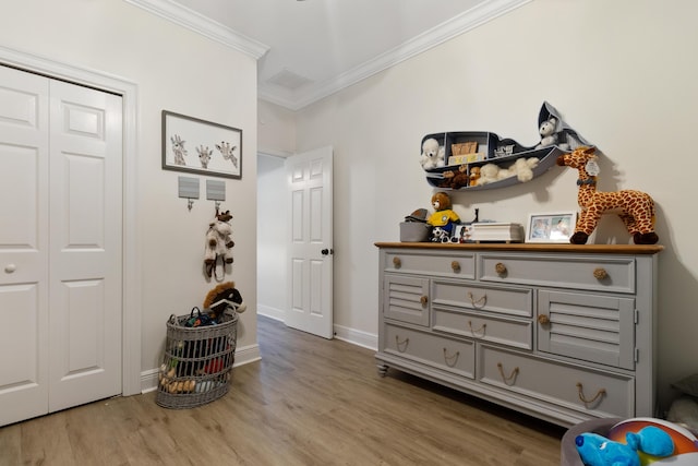 1009 Forest Shore Dr, Miramar Beach, FL 32550 - bedroom with crown molding, wood finished floors, and a closet