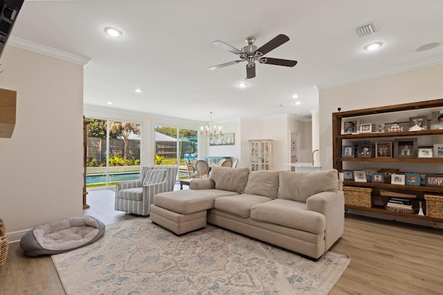 1009 Forest Shore Dr, Miramar Beach, FL 32550 - living area with ornamental molding, a ceiling fan, a chandelier, light wood-style flooring, and recessed lighting