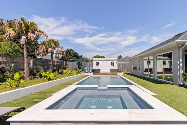 1009 Forest Shore Dr, Miramar Beach, FL 32550 - view of swimming pool with a fenced backyard, a storage unit, and a pool with connected hot tub