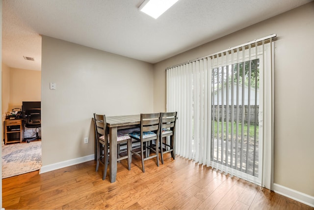 2808 Ping Ln, Crestview, FL 32539 - dining space featuring wood finished floors and a textured ceiling