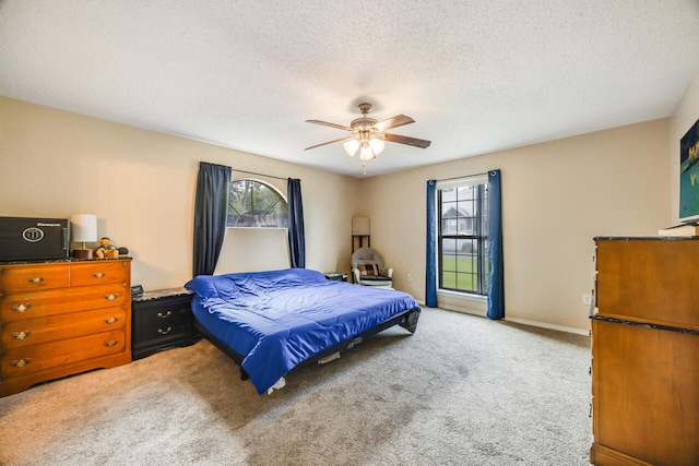 2808 Ping Ln, Crestview, FL 32539 - bedroom featuring multiple windows, carpet flooring, a textured ceiling, and ceiling fan