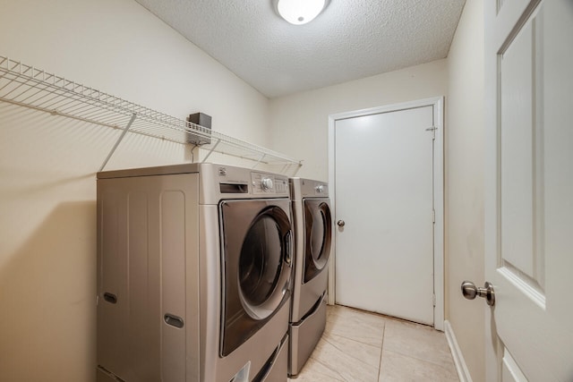 2808 Ping Ln, Crestview, FL 32539 - washroom with washing machine and clothes dryer, light tile patterned floors, and a textured ceiling