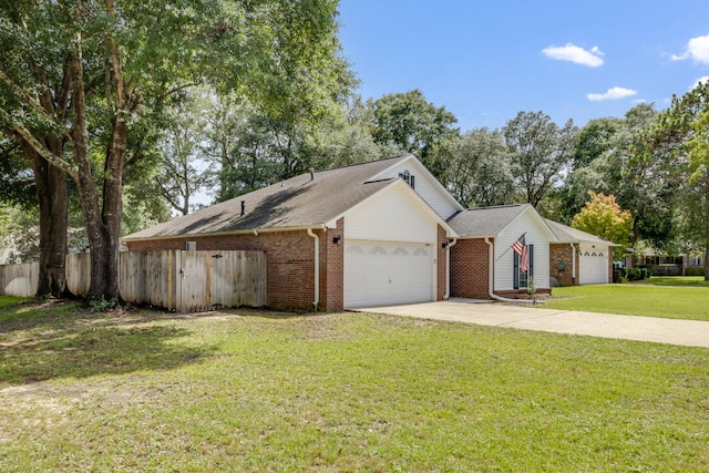 2808 Ping Ln, Crestview, FL 32539 - ranch-style home with brick siding, an attached garage, driveway, and view of scattered trees