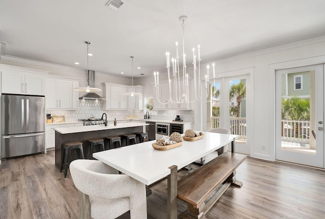 65 Sandy Shores Ct, Inlet Beach, FL 32461 - dining space with a chandelier, wood finished floors, ornamental molding, beverage cooler, and recessed lighting