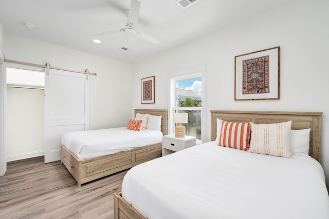 65 Sandy Shores Ct, Inlet Beach, FL 32461 - bedroom with light wood-type flooring, a barn door, a ceiling fan, and recessed lighting