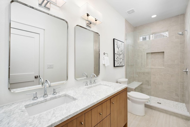 65 Sandy Shores Ct, Inlet Beach, FL 32461 - bathroom featuring a tile shower, double vanity, wood finished floors, and recessed lighting