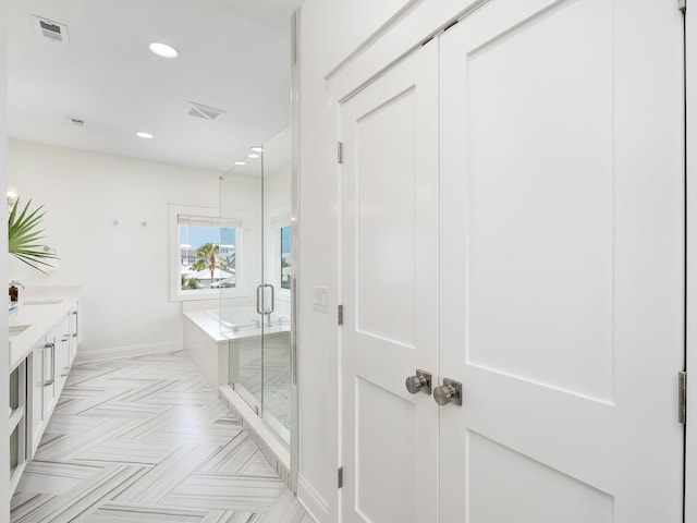 65 Sandy Shores Ct, Inlet Beach, FL 32461 - bathroom with double vanity, a bath, a stall shower, and recessed lighting