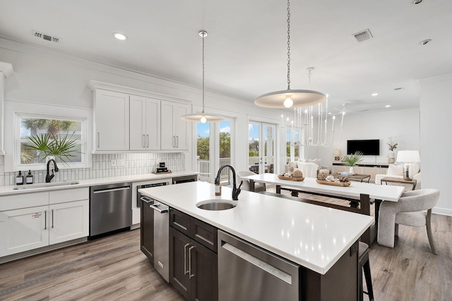 65 Sandy Shores Ct, Inlet Beach, FL 32461 - kitchen with dishwasher, light countertops, recessed lighting, light wood-style floors, and tasteful backsplash