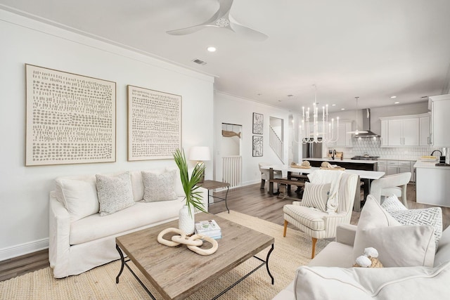 65 Sandy Shores Ct, Inlet Beach, FL 32461 - living area featuring light wood finished floors, recessed lighting, ornamental molding, a chandelier, and stairway