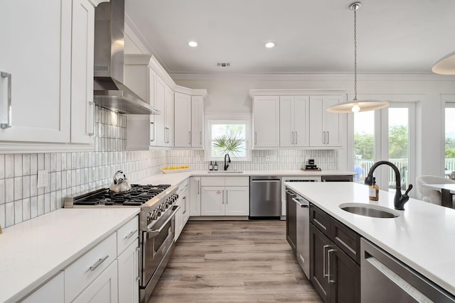 65 Sandy Shores Ct, Inlet Beach, FL 32461 - kitchen with stainless steel appliances, wall chimney exhaust hood, light countertops, white cabinets, and ornamental molding