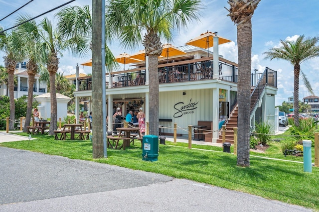 102 Terra Cotta Way, Destin, FL 32541 - view of front of home featuring a front yard, a balcony, and stairs