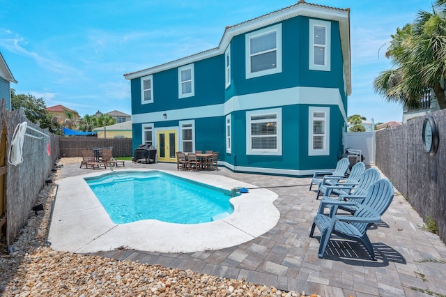 102 Terra Cotta Way, Destin, FL 32541 - back of property with french doors, a patio, a fenced backyard, and outdoor dining space