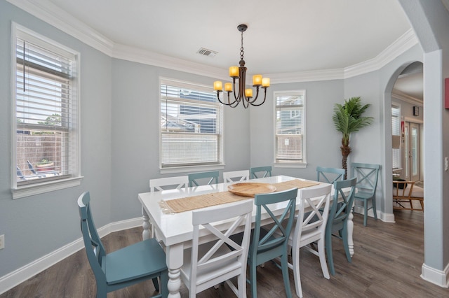 102 Terra Cotta Way, Destin, FL 32541 - dining room featuring arched walkways, a chandelier, plenty of natural light, dark wood-style flooring, and ornamental molding