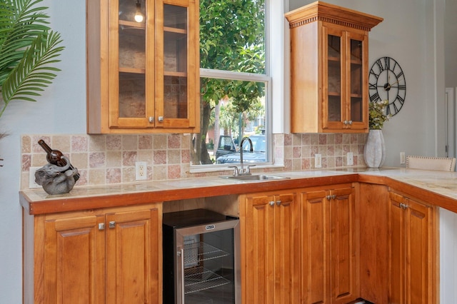 102 Terra Cotta Way, Destin, FL 32541 - kitchen with beverage cooler, tasteful backsplash, glass insert cabinets, brown cabinetry, and tile countertops