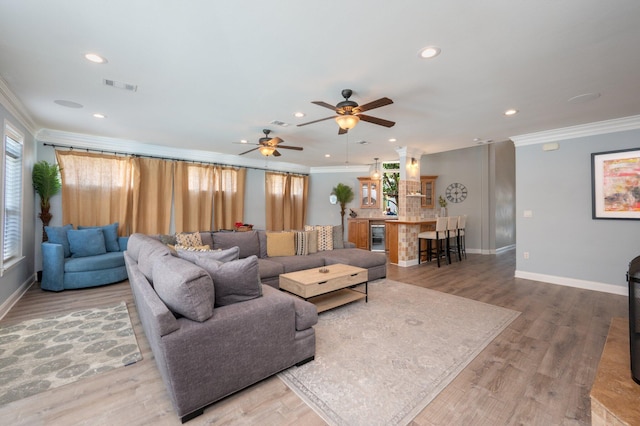 102 Terra Cotta Way, Destin, FL 32541 - living room featuring crown molding, ceiling fan, recessed lighting, wine cooler, and wood finished floors
