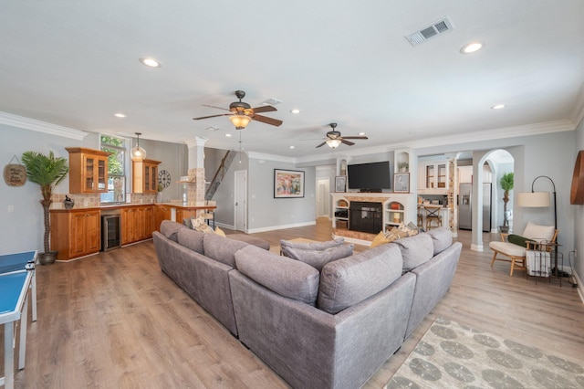 102 Terra Cotta Way, Destin, FL 32541 - living area with beverage cooler, ceiling fan, recessed lighting, arched walkways, and crown molding