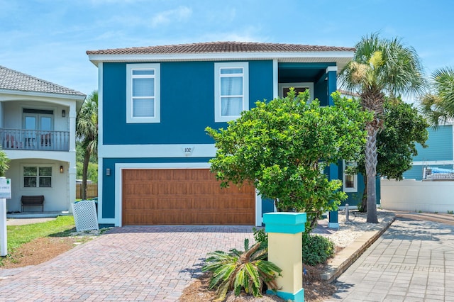 102 Terra Cotta Way, Destin, FL 32541 - view of front of home featuring a garage, decorative driveway, stucco siding, and a tiled roof