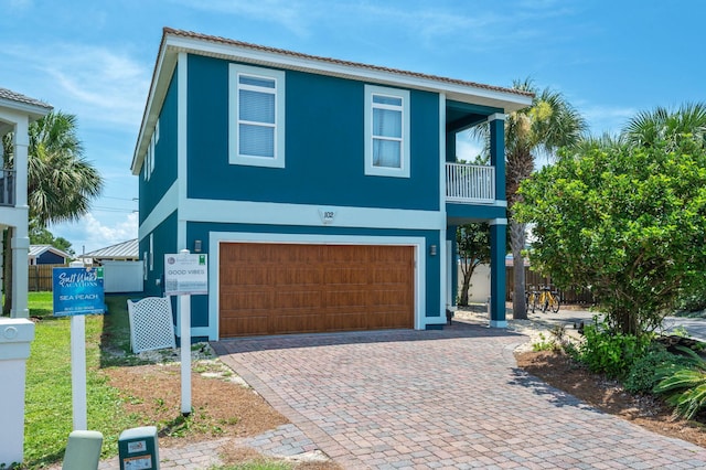 102 Terra Cotta Way, Destin, FL 32541 - coastal inspired home featuring a garage, stucco siding, and decorative driveway