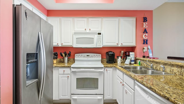122 Seascape Dr Unit 902, Miramar Beach, FL 32550 - kitchen featuring white appliances, white cabinets, a peninsula, and light stone countertops