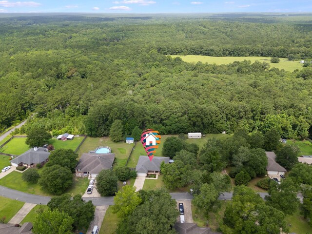 48 S Pleasant Dr, Defuniak Springs, FL 32435 - aerial view of property and surrounding area featuring a heavily wooded area