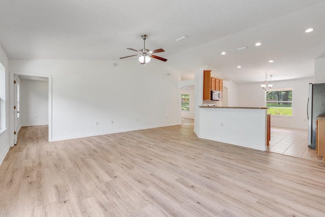 48 S Pleasant Dr, Defuniak Springs, FL 32435 - unfurnished living room with a ceiling fan, a chandelier, recessed lighting, light wood-style flooring, and arched walkways