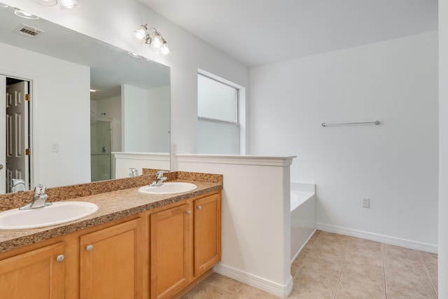 48 S Pleasant Dr, Defuniak Springs, FL 32435 - bathroom featuring a stall shower, double vanity, a bath, and tile patterned flooring