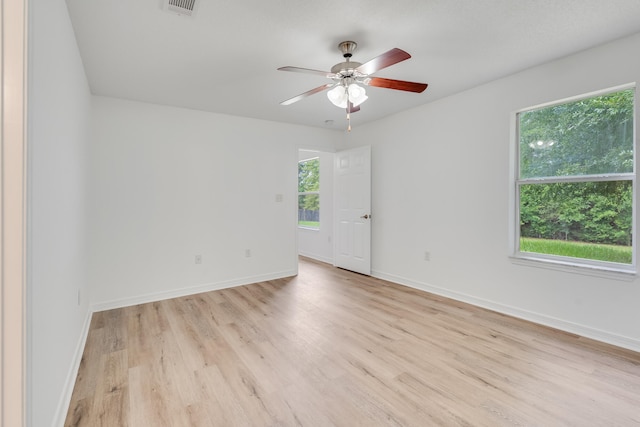 48 S Pleasant Dr, Defuniak Springs, FL 32435 - empty room featuring healthy amount of natural light, a ceiling fan, and light wood-style flooring