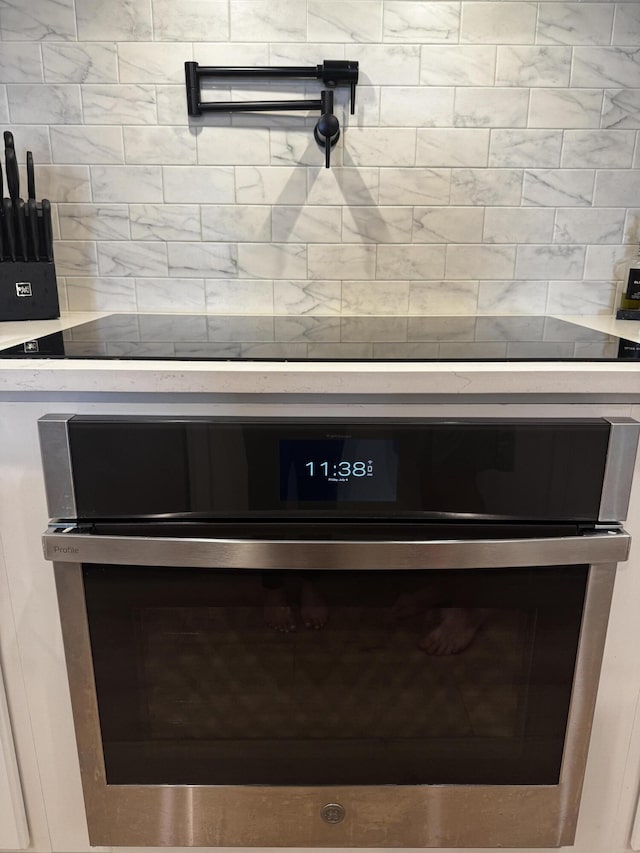 136 Hibernate Way, Freeport, FL 32439 - kitchen view of stainless steel oven, pot filler, and decorative backsplash