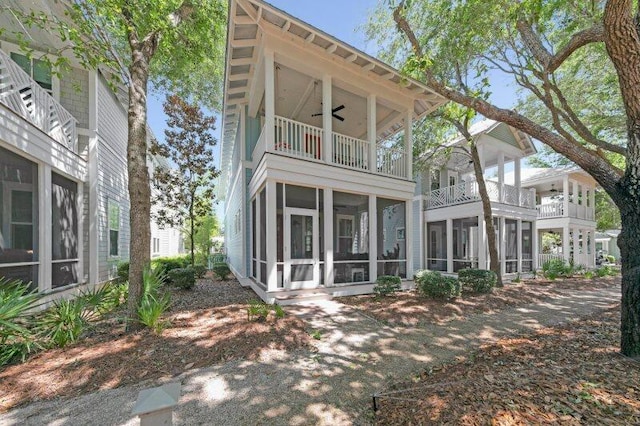 38 Blazing Star Dr, Santa Rosa Beach, FL 32459 - back of property with a balcony, ceiling fan, and a sunroom