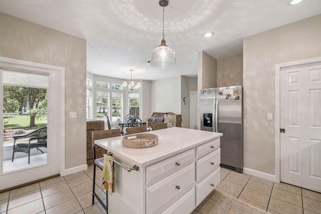 172 Shady Ln, Freeport, FL 32439 - kitchen featuring stainless steel fridge with ice dispenser, white cabinetry, a chandelier, light tile patterned flooring, and decorative light fixtures