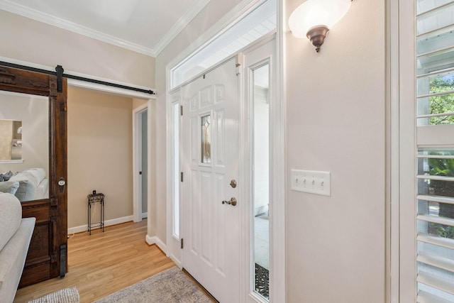 172 Shady Ln, Freeport, FL 32439 - entryway featuring crown molding, light wood-style floors, and a barn door