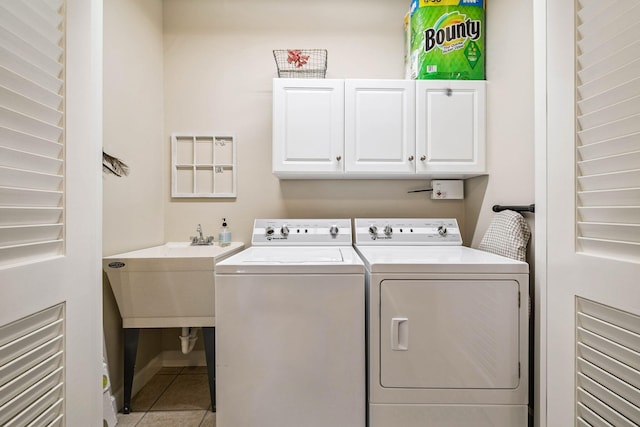 172 Shady Ln, Freeport, FL 32439 - laundry area with cabinet space, washing machine and clothes dryer, and tile patterned floors