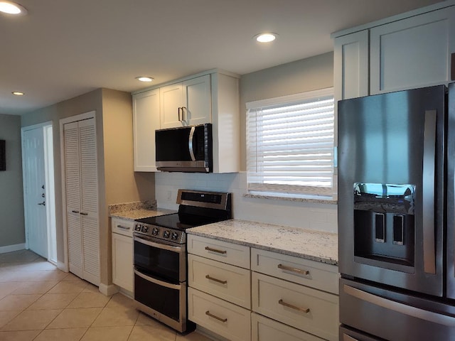955 Scenic Gulf Dr Unit 410, Miramar Beach, FL 32550 - kitchen featuring appliances with stainless steel finishes, light stone counters, light tile patterned floors, decorative backsplash, and recessed lighting