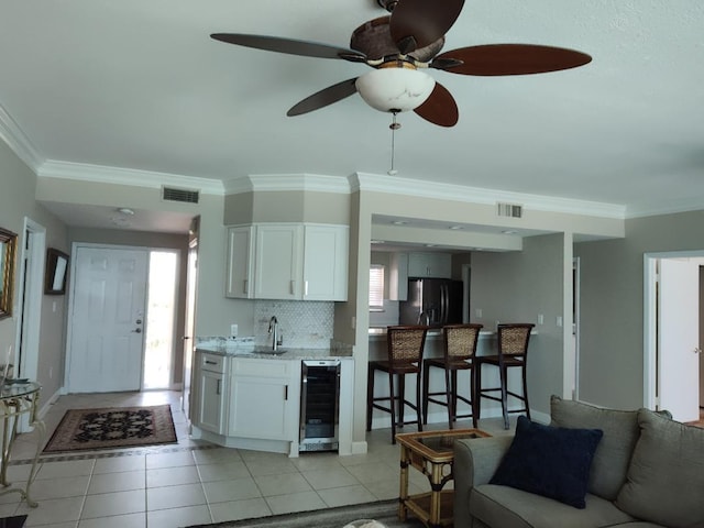 955 Scenic Gulf Dr Unit 410, Miramar Beach, FL 32550 - kitchen featuring wine cooler, black fridge with ice dispenser, light tile patterned floors, healthy amount of natural light, and ornamental molding