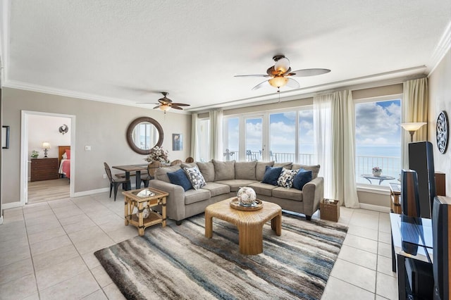955 Scenic Gulf Dr Unit 410, Miramar Beach, FL 32550 - living area featuring a ceiling fan, light tile patterned floors, crown molding, healthy amount of natural light, and a textured ceiling