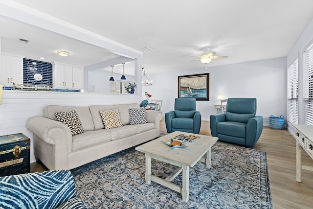 727 Sandpiper Pl # 10516, Miramar Beach, FL 32550 - living area with light wood-type flooring, a ceiling fan, and a chandelier