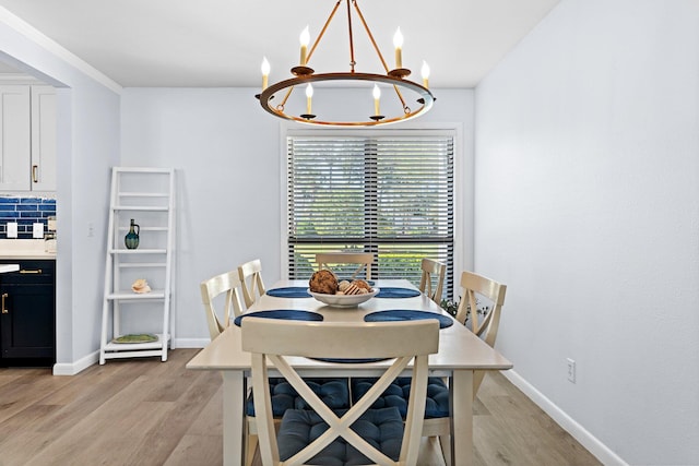 727 Sandpiper Pl # 10516, Miramar Beach, FL 32550 - dining room with a chandelier and light wood finished floors