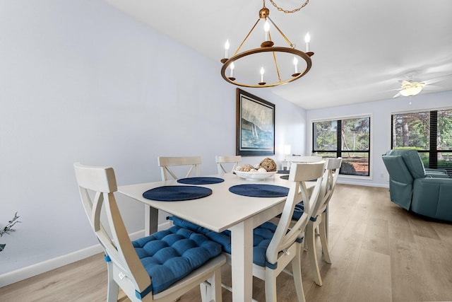 727 Sandpiper Pl # 10516, Miramar Beach, FL 32550 - dining area with a chandelier, light wood-style floors, and vaulted ceiling