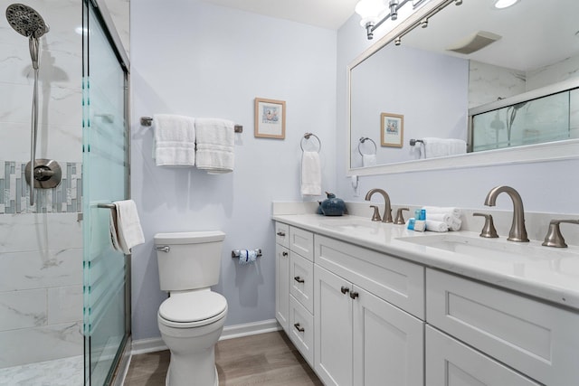 727 Sandpiper Pl # 10516, Miramar Beach, FL 32550 - bathroom with double vanity, a marble finish shower, and wood finished floors