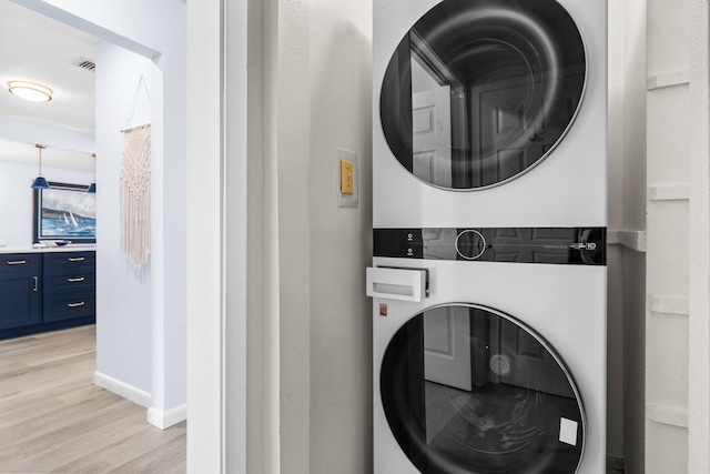 727 Sandpiper Pl # 10516, Miramar Beach, FL 32550 - laundry room featuring stacked washer / drying machine and light wood finished floors