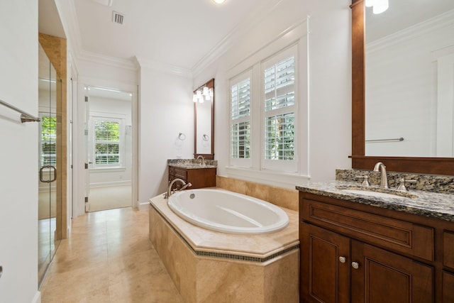 9 W Salt Box Ln, Watersound, FL 32461 - full bathroom with two vanities, ornamental molding, a bath, a stall shower, and tile patterned floors