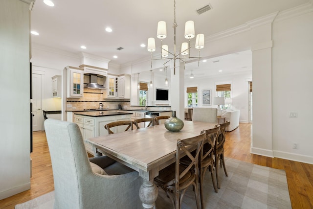 9 W Salt Box Ln, Watersound, FL 32461 - dining space featuring ornamental molding, light wood-style flooring, recessed lighting, a chandelier, and ceiling fan