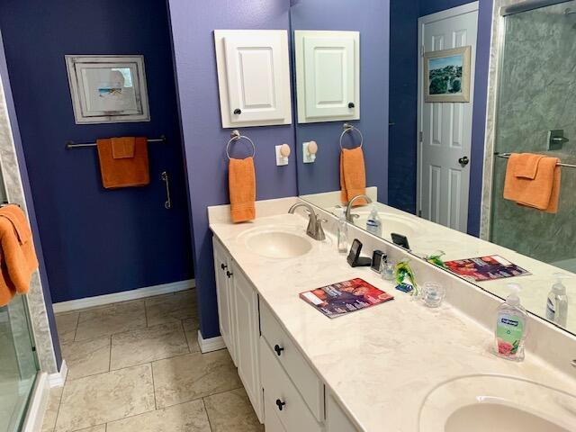 4643 Windstarr Dr, Destin, FL 32541 - bathroom with double vanity and a stall shower