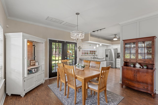 3228 Mcmillan Creek Dr, Milton, FL 32583 - dining area with wood finished floors, a chandelier, ornamental molding, ceiling fan, and french doors