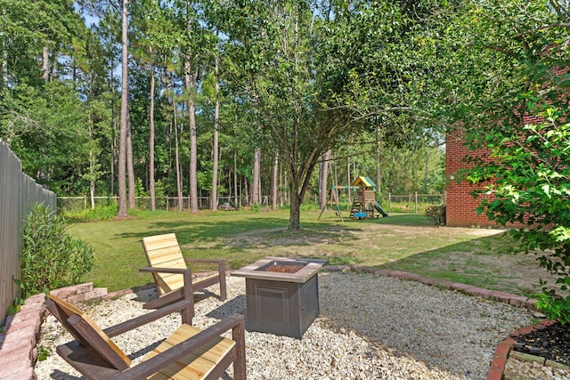 3228 Mcmillan Creek Dr, Milton, FL 32583 - fenced backyard with an outdoor fire pit and a playground